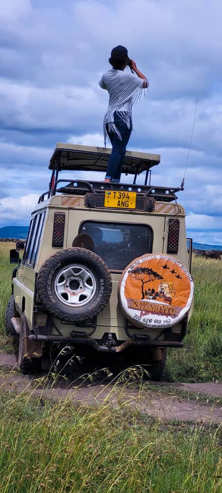 Traveller watching the sunrise over Tanzania wilderness during a nature safari